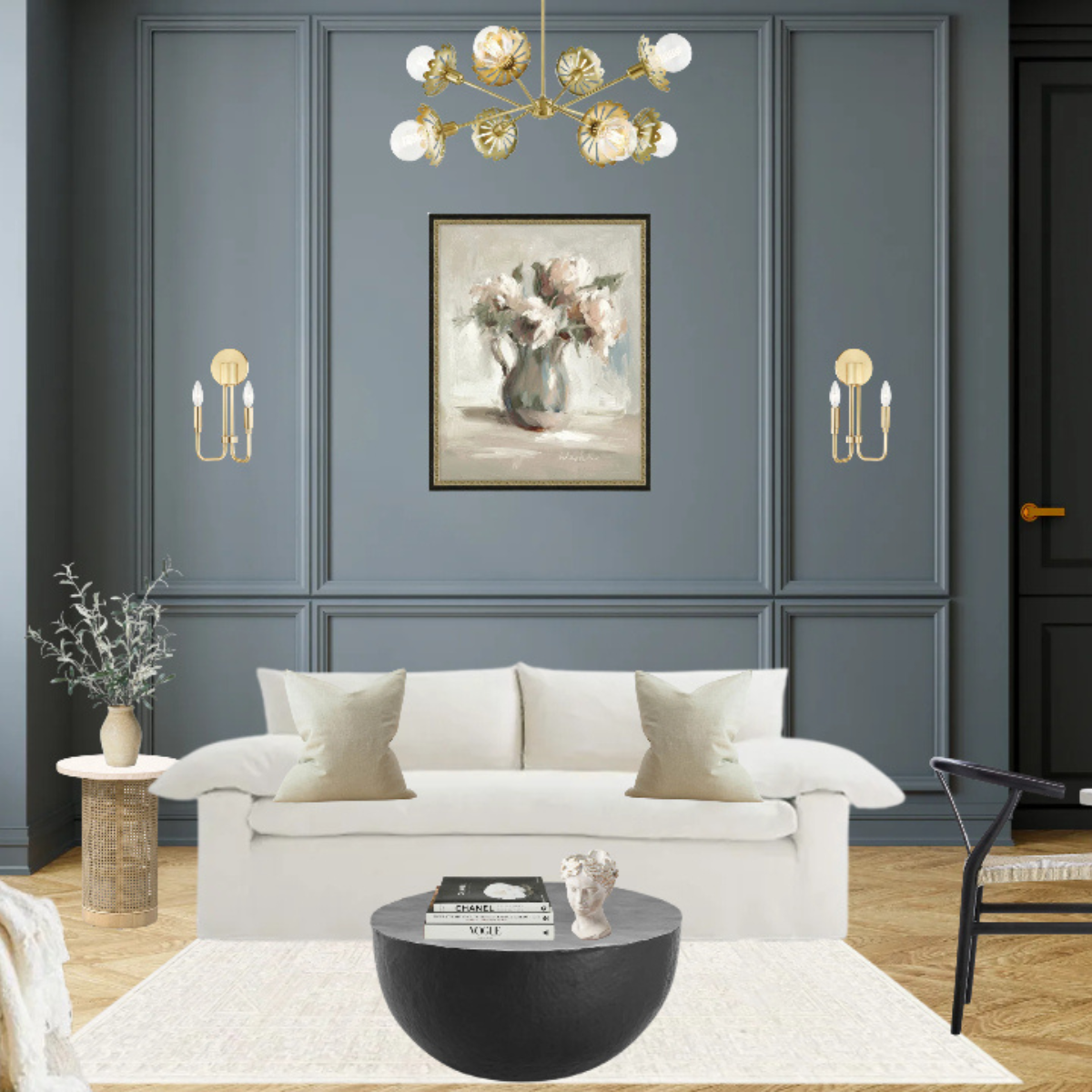 Living room with a white sofa beneath a brass multi-arm chandelier and matching brass wall sconces on a blue paneled wall