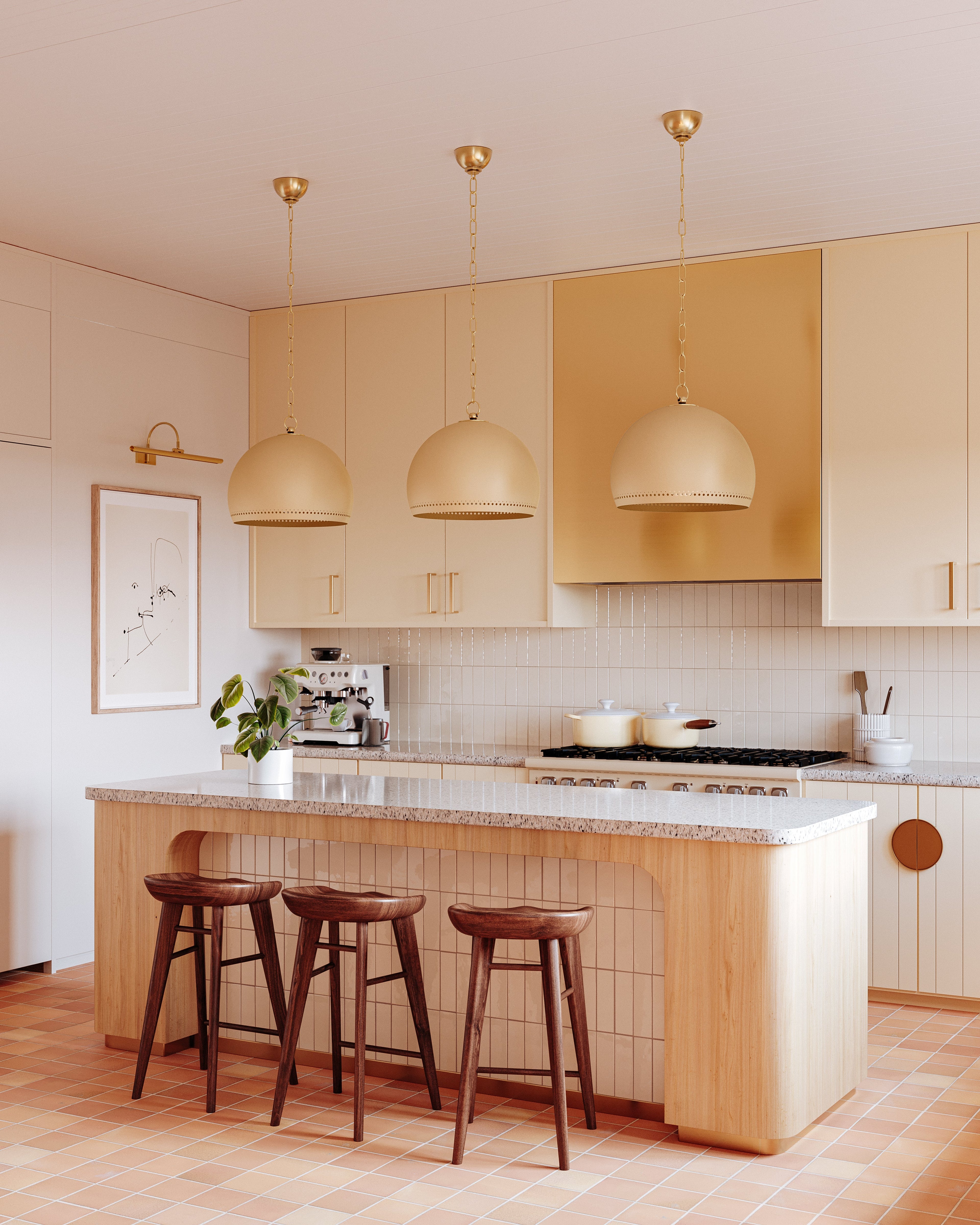Elowen picture light mounted above framed art in a warm-toned kitchen with three dome pendants and a breakfast island